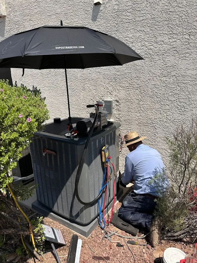 HVAC technician performing outdoor AC maintenance in St. Simons